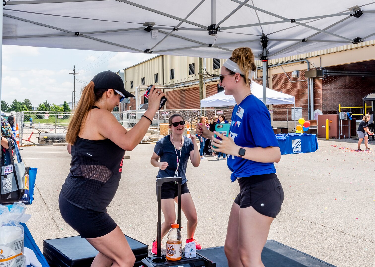 three women doing step aerobics