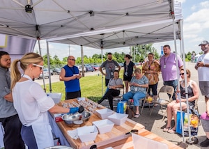 woman cooking at food demo in front of an audience