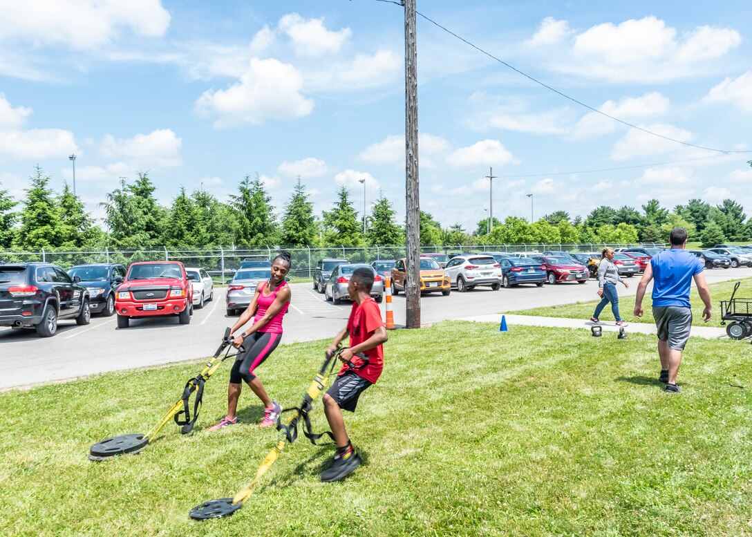 people racing pulling weights