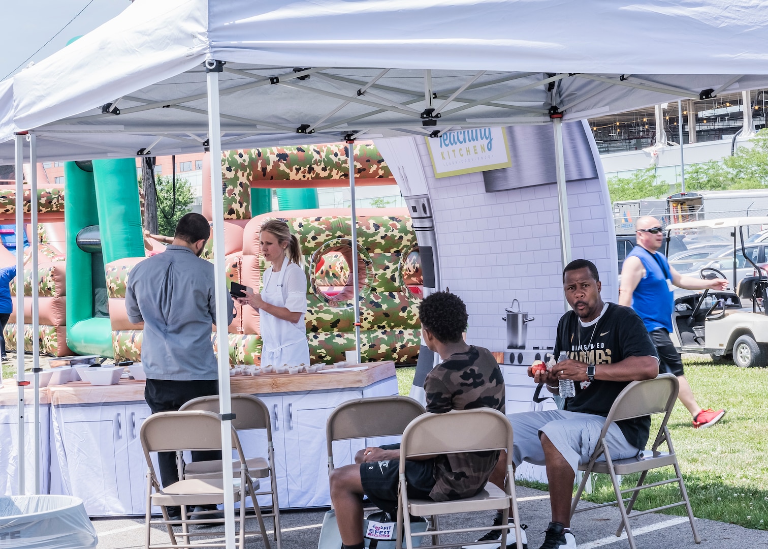 people under a pop-up tent