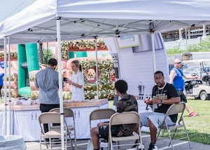 people under a pop-up tent