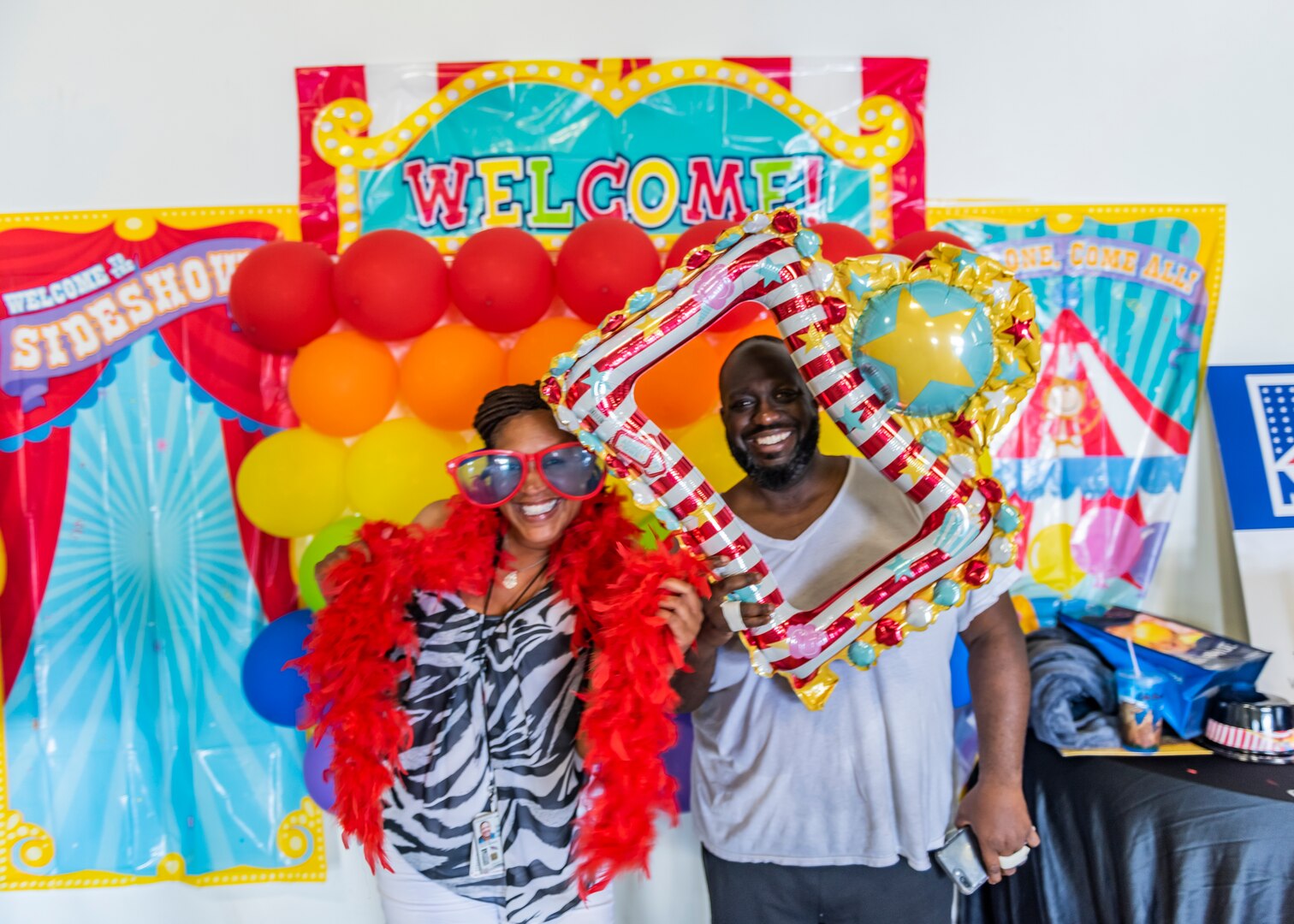 Man and women take photo with props