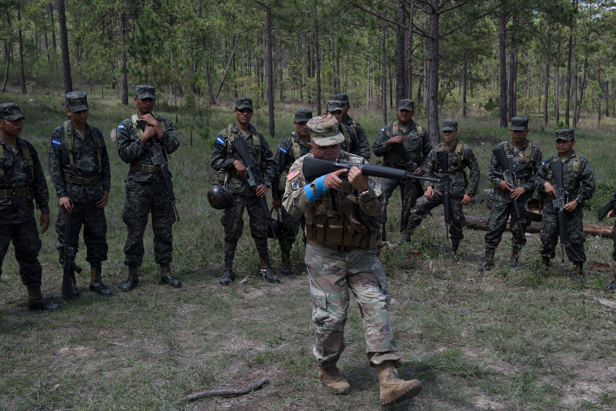 U.S. Army Staff Sgt. Roberto Santini, Puerto Rico National Guard Security Forces Training (SFT) instructor, demonstrates weapon-handling techniques to a group Honduran soldiers during the SFT course June 8, 2019, at the 1st Artillery Battalion in Zambrano, Honduras. Honduran Army soldiers participated in the two-week SFT course led by U.S. Army Puerto Rico National Guard service members assigned to Task Force ¬¬– Borinqueneer. The course taught them about security techniques and procedures to include formation, breaching, weapons training, casualty care, vehicle searching and tactical control points. The training was hosted as way to strengthen the host nations counter threat ability. (U.S. Air Force photo by Staff Sgt. Eric Summers Jr.)