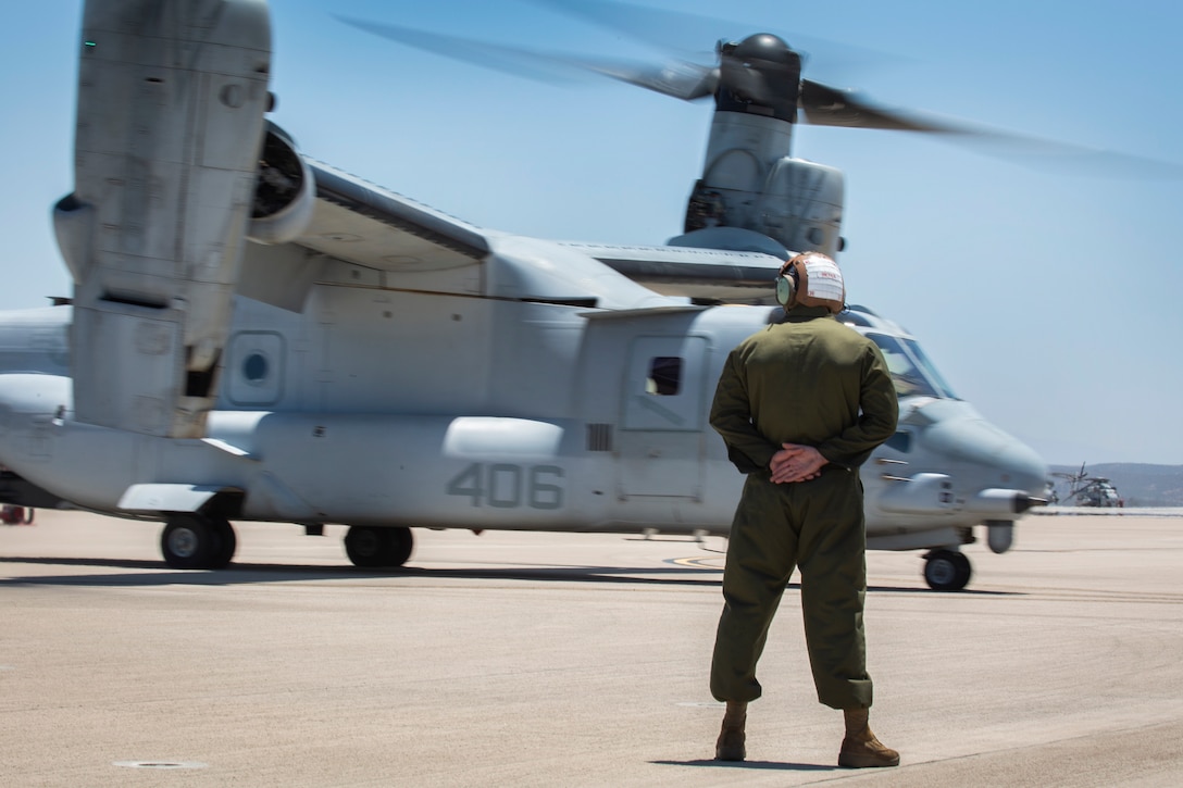 A Marine with Marine Medium Tiltrotor Squadron (VMM) 764, 4th Marine Aircraft Wing, stands on the flight line before the MV-22B Ospreys take off from Marine Corps Air Station Miramar, Calif., June 12. Once a year reserve components of the Marine Corps go on two-week annual training detachments to sharpen their skills in their military occupational specialties. (U.S. Marine Corps photo by Sgt. Becky Cleveland)