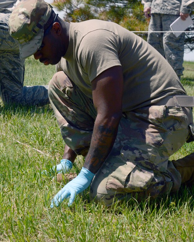 Senior Airman Brian Williams, 341st Force Support Squadron food services journeyman, participates in a search and recovery exercise June 12, 2019, at Malmstrom Air Force Base, Mont. The Airmen were required to wear personal protective equipment as they would in real life including, but not limited to, latex gloves, respirators, and hazardous materials suits to combat blood-borne pathogens. (U.S. Air Force photo by Staff Sgt. Magen M. Reeves)