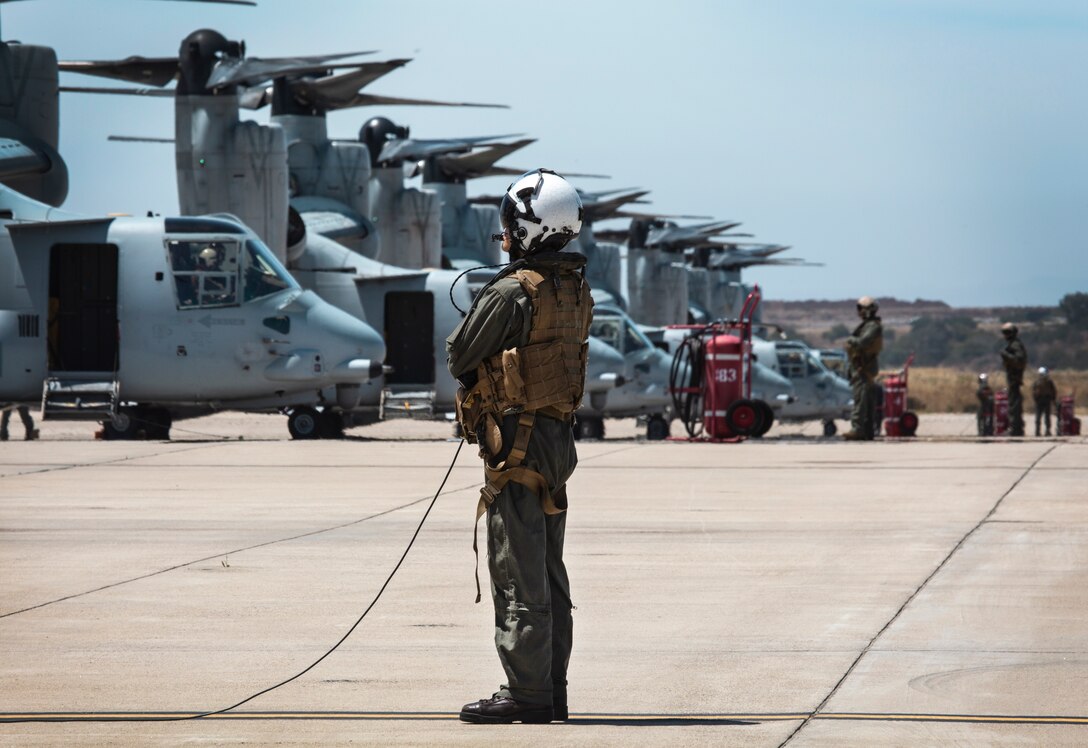 A crew chief with Marine Medium Tiltrotor Squadron (VMM) 764, 4th Marine Aircraft Wing, prepare an MV-22B Osprey on the flight line before taking off from Marine Corps Air Station Miramar, Calif., June 12. Once a year reserve components of the Marine Corps go on two-week annual training detachments to sharpen their skills in their military occupational specialties. (U.S. Marine Corps photo by Sgt. Becky Cleveland)