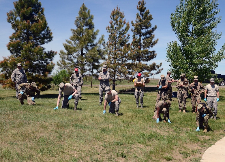 Airmen from the 341st Force Support Squadron participate in a search and recovery exercise June 12, 2019, at Malmstrom Air Force Base, Mont. Airmen from the squadron gathered to learn how to properly search, recover, identify and document remains, portions and effects associated with search and recovery operations. (U.S. Air Force photo by Staff Sgt. Magen M. Reeves)