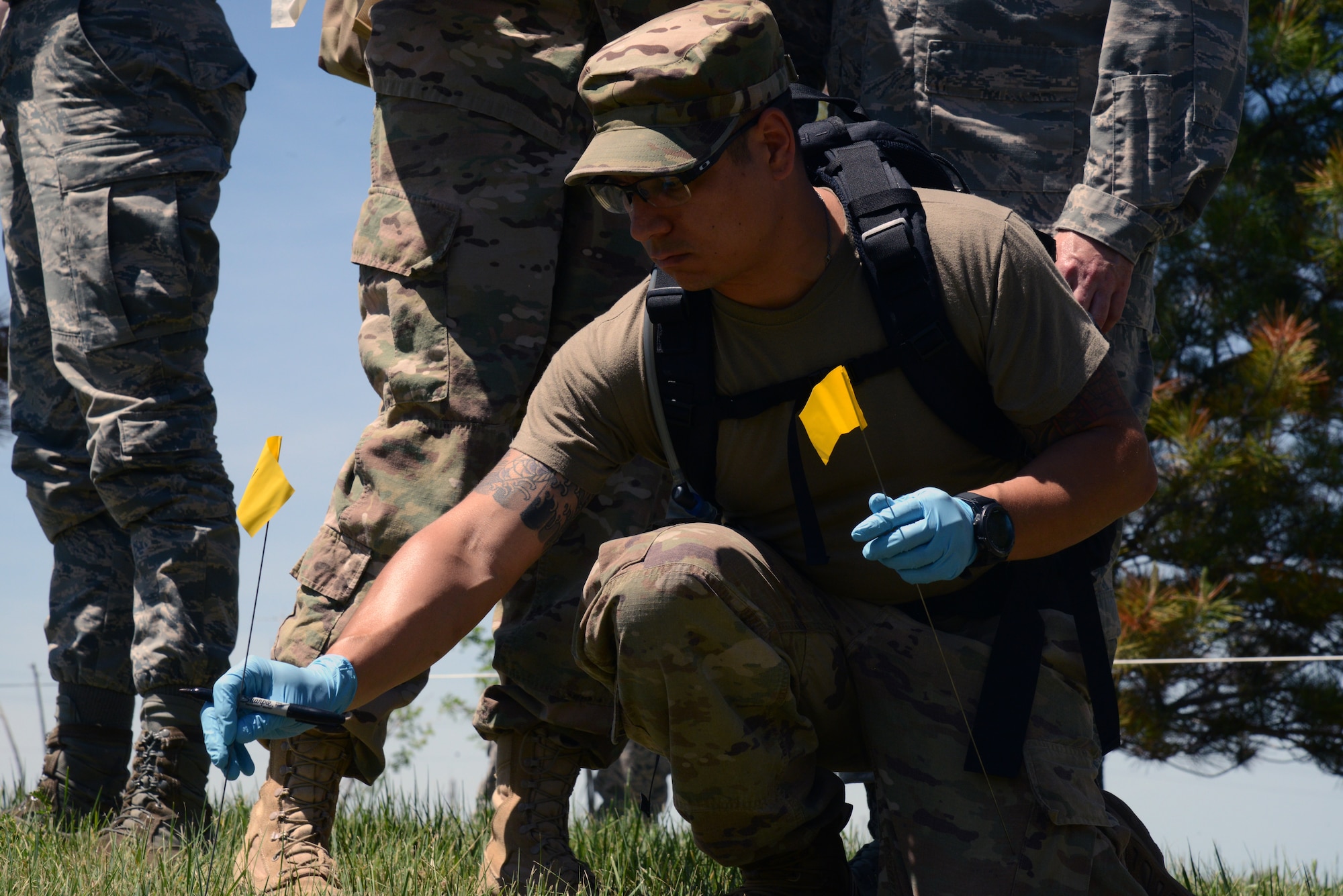 Tech. Sgt. Luis Escobar, 341st Force Support Squadron fitness and sports non-commissioned office in charge, participates in a search and recovery exercise June 12, 2019, at Malmstrom Air Force Base, Mont. The exercise included ensuring all identifications made are marked with flags, are recorded in a ledger, photographed, and latitude and longitude coordinates are documented. (U.S. Air Force photo by Staff Sgt. Magen M. Reeves)