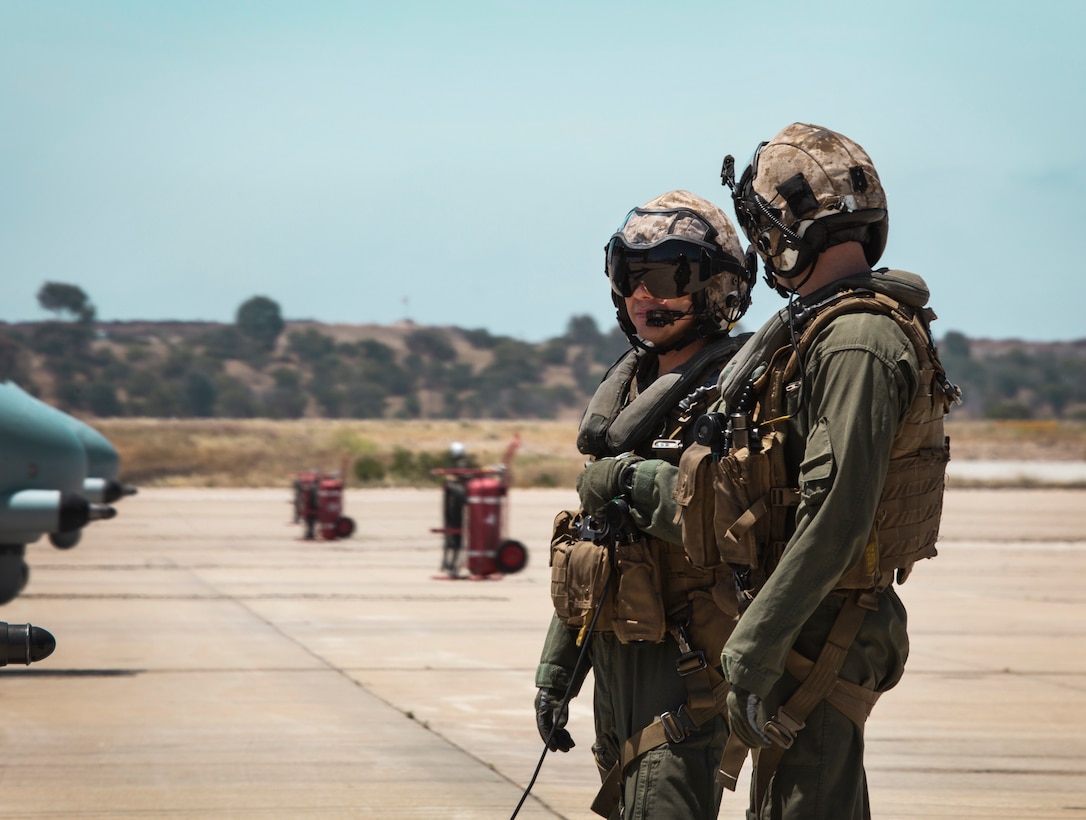 Two crew chiefs with Marine Medium Tiltrotor Squadron (VMM) 764, 4th Marine Aircraft Wing, conversate on the flight line before taking off from Marine Corps Air Station Miramar, Calif., June 12. Once a year reserve components of the Marine Corps go on two-week annual training detachments to sharpen their skills in their military occupational specialties. (U.S. Marine Corps photo by Sgt. Becky Cleveland)