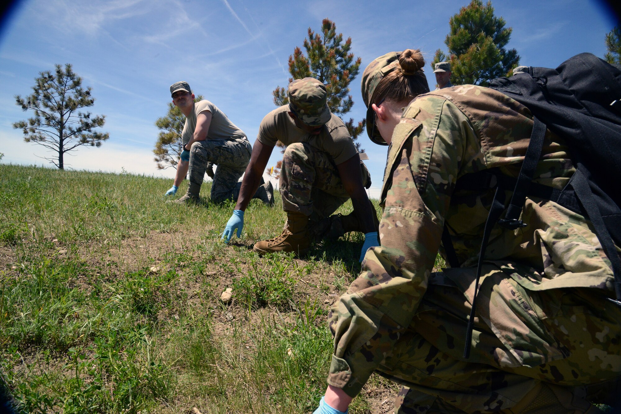 Airman 1st Class Amanda Deringer (right), Senior Airman Brian Williams (center), and other Airmen from the 341st Force Support Squadron, participate in a search and recovery exercise June 12, 2019, at Malmstrom Air Force Base, Mont. The exercise simulated an aircraft crash site, requiring the Airmen to search the terrain for any for remains of individuals or parts of the fictitious aircraft. (U.S. Air Force photo by Staff Sgt. Magen M. Reeves)