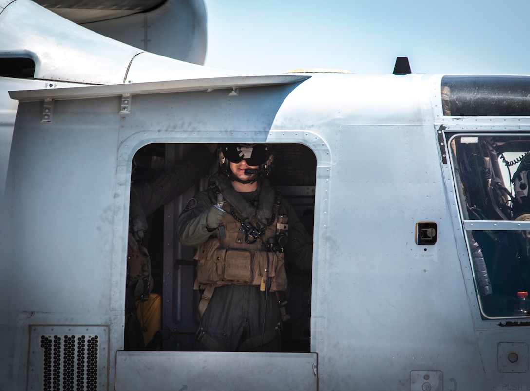 A crew chief with Marine Medium Tiltrotor Squadron (VMM) 764, 4th Marine Aircraft Wing, gives a thumbs up in an MV-22B Osprey before taking off from Marine Corps Air Station Miramar, Calif., June 12. Once a year reserve components of the Marine Corps go on two-week annual training detachments to sharpen their skills in their military occupational specialties. (U.S. Marine Corps photo by Sgt. Becky Cleveland)