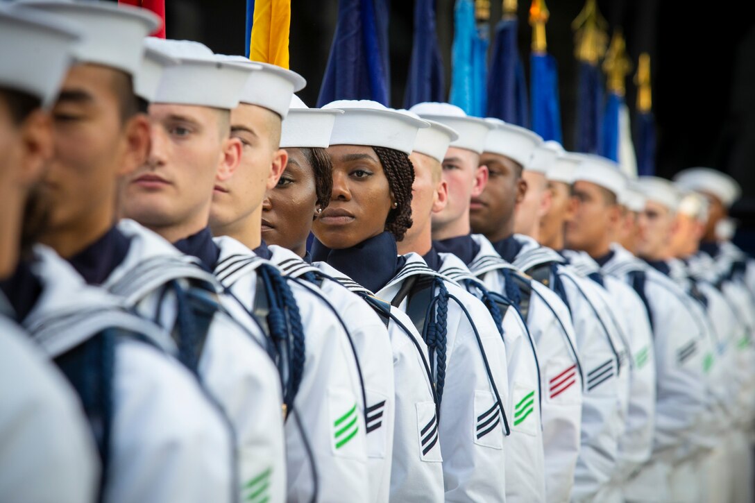 A group of sailors stand in a line.