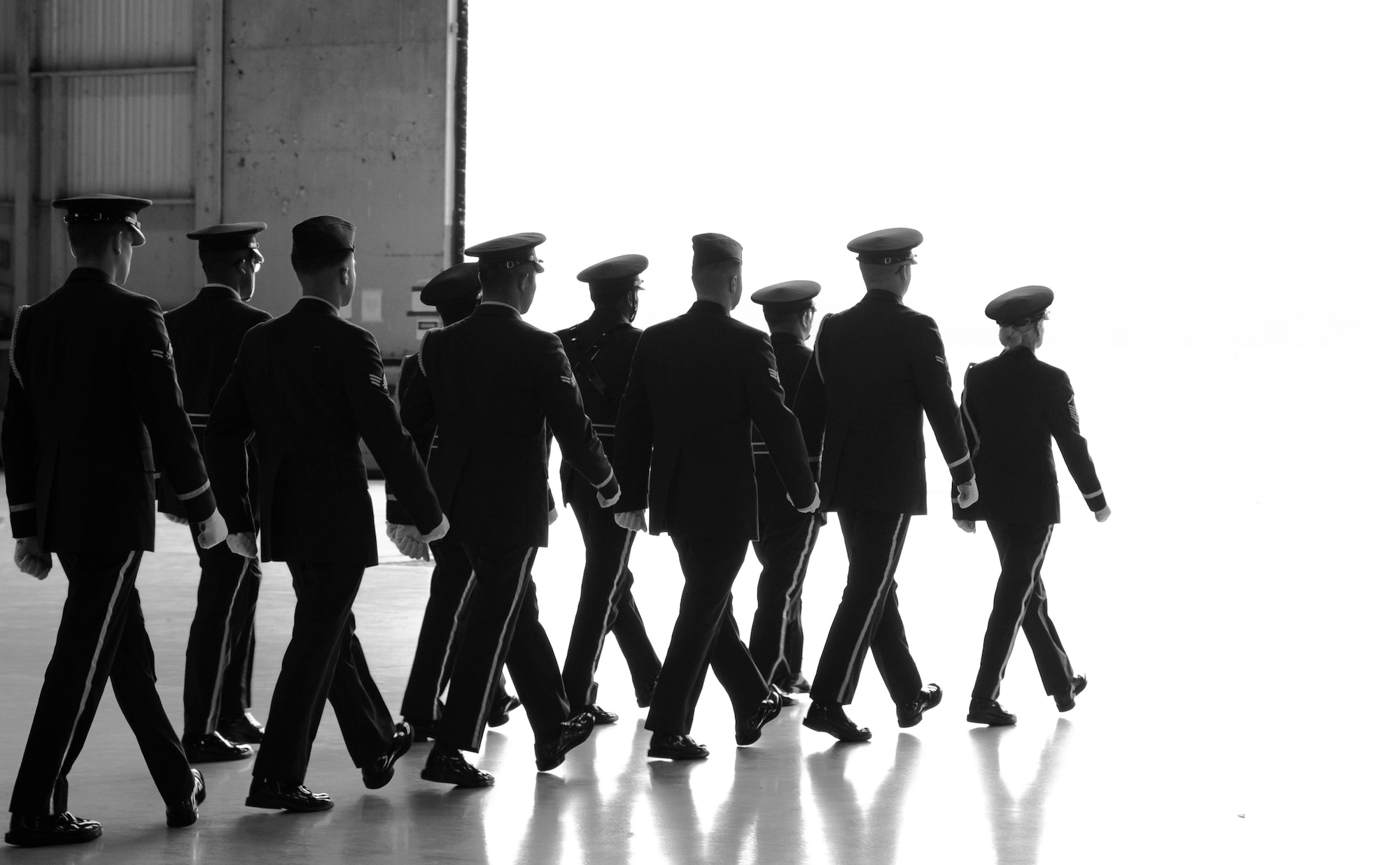 U.S Airmen assigned to the 20th Force Support Squadron Honor Guard march out of Hanger 1200 following a memorial service at Shaw Air Force Base, South Carolina, June 7, 2019.