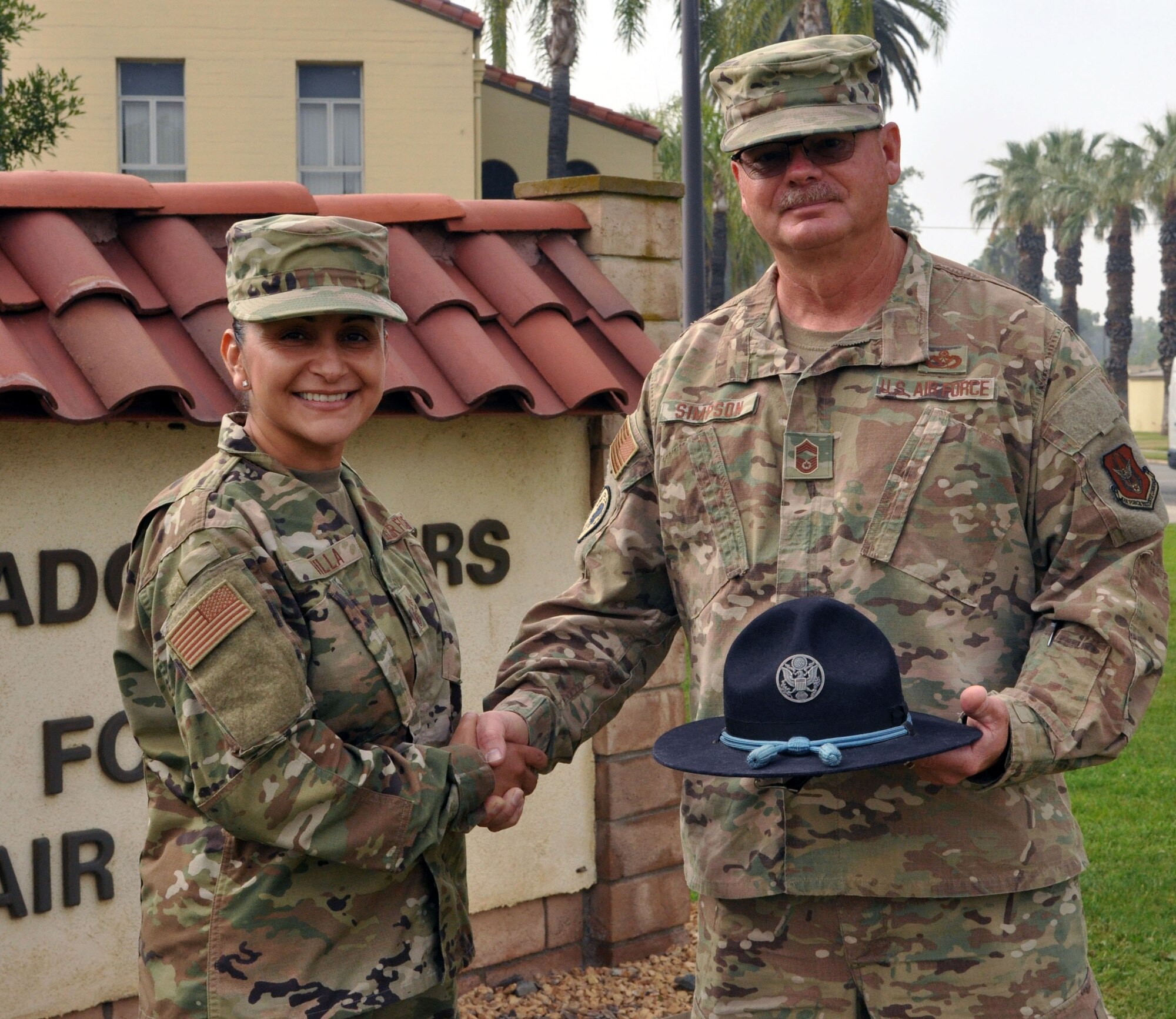 Chief Master Sgt. Cynthia Villa, 4th Air Force command chief,  shakes hands with her former basic military training instructor Chief Master Sgt. Steve Simpson, June 13, 2019 at March Air Reserve Base, California. (U.S. Air Force photo by Candy Knight)