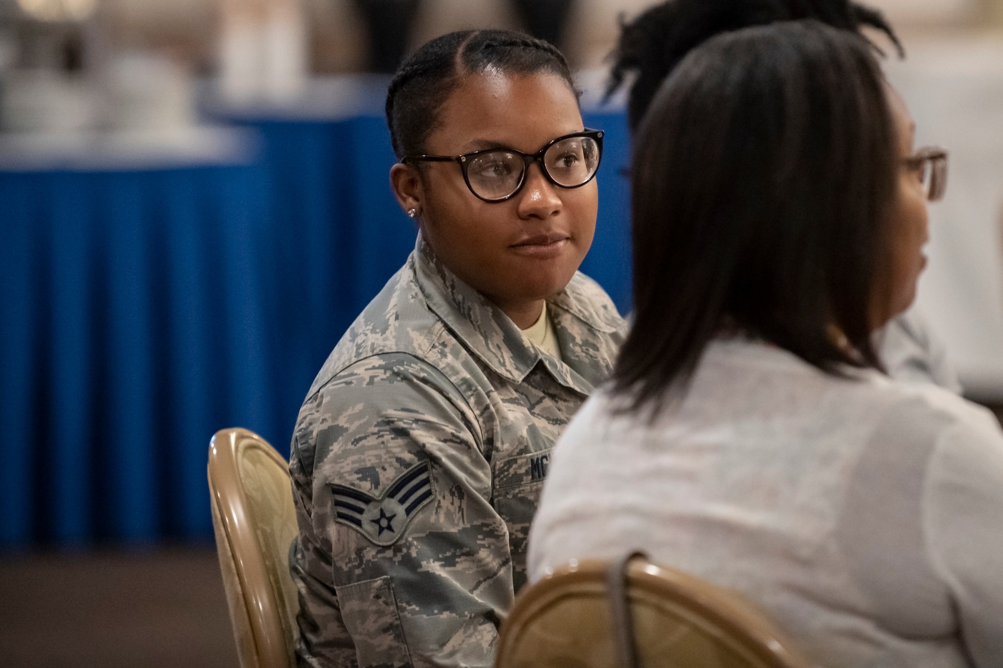 U.S. Air Force Senior Airman Diamond McNutt, a material management specialist assigned to the 307th Logistics and Readiness Squadron, listens to a speaker at the Shreveport Bossier Military Affairs Council quarterly update luncheon at Barksdale Air Force Base, Louisiana, June 12, 2019. McNutt earned a $1,000 scholarship from the MAC, which she will use to earn a bachelor's degree in biology. (U.S. Air Force photo by Senior Airman Maxwell Daigle)