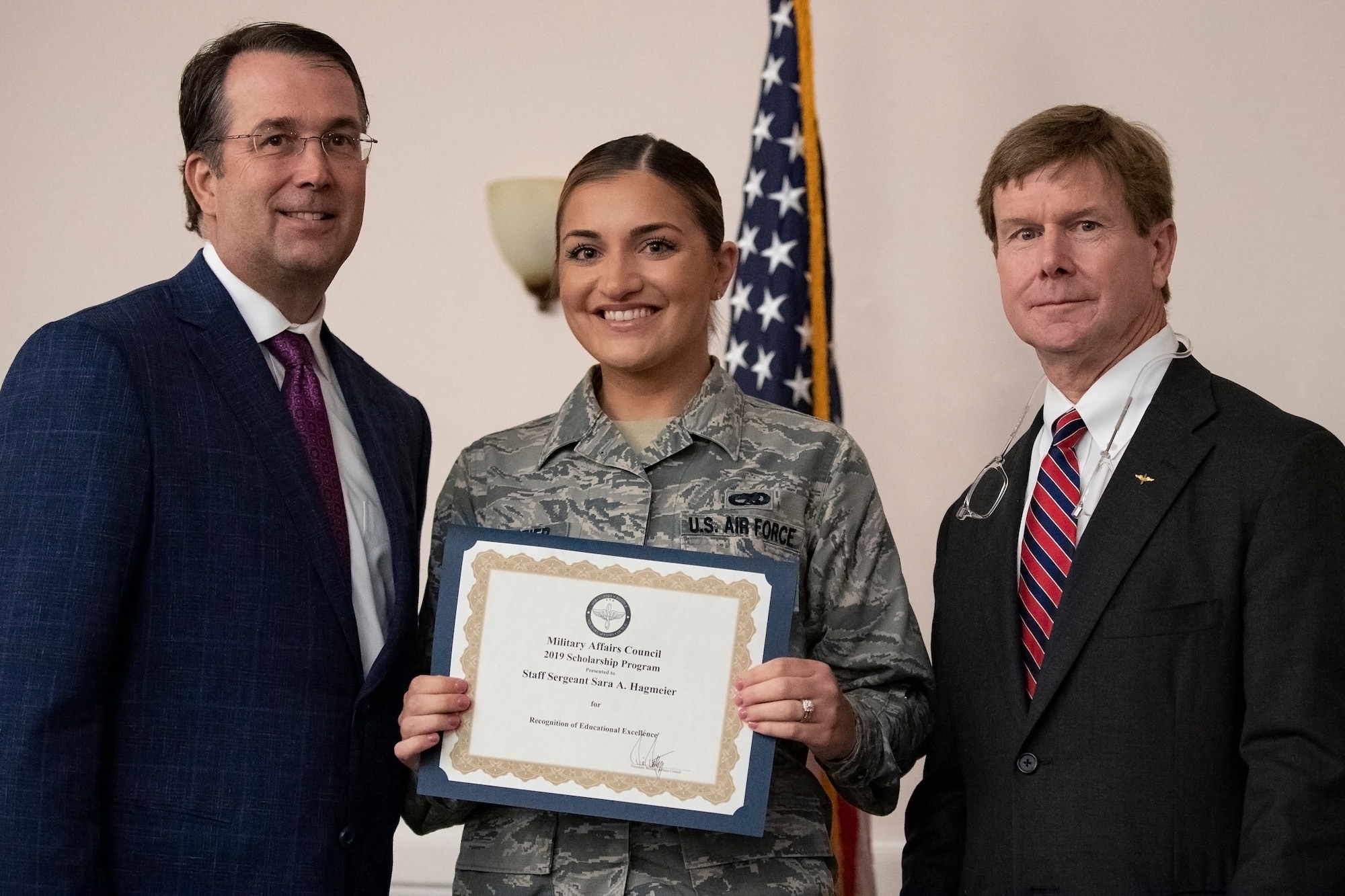 Representatives from the Shreveport-Bossier Military Affairs council present a $1,000 academic scholarship to U.S. Air Force Staff Sgt. Sara Hagmeier, 307th Maintenance Group aircraft scheduler, at Barksdale Air Force Base, Louisiana, June 12, 2019. Hagmeier will use her scholarship to earn an associate's degree in diagnostic medical sonography. (U.S. Air Force photo by Senior Airman Maxwell Daigle)