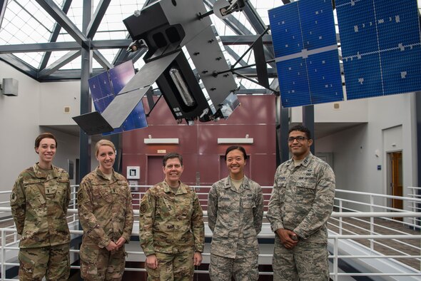 (From left to right) 1st Lt. Catherine Willis and 1st Lt. Robyn Hayes, incoming Space Intelligence Intern Program interns, Col. Suzy Streeter, Air Force Space Command/Intelligence, Surveillance and Reconnaissance director and 1st Lt. Rebecca Bosworth and Capt. Devin Hightower, current SIIP interns, stand in front of the Space-Based Infrared System model at HQ, AFSPC on Peterson Air Force Base, Colorado, June 11, 2019. The Airmen are involved in SIIP, a 24-month program designed to improve the space foundational intelligence base for participants to succeed in future space intelligence leadership roles. (U.S. Air Force photo by 2nd Lt. Kristen Shimkus)