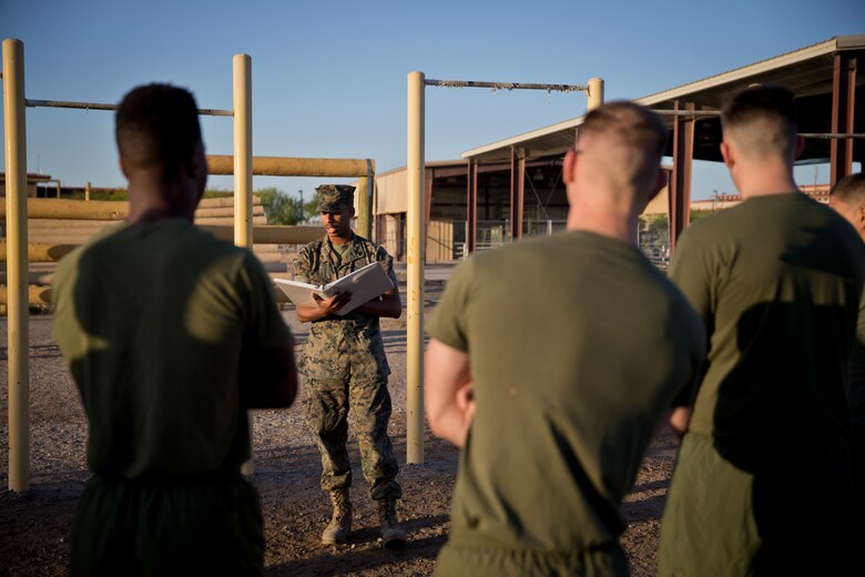 U.S. Marines with Headquarters and Headquarters Squadron, Marine Corps Air Station Yuma, conduct the pull-up portion of the Physical Fitness Test (PFT) at Marine Corps Air Station Yuma Ariz., May 8, 2019. The PFT is an annual requirement for all Marines, and consists of pull-ups, crunches, and a 3 mile run. (U.S. Marine Corps photo by Lance Cpl. Joel Soriano)