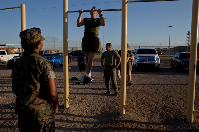 U.S. Marines with Headquarters and Headquarters Squadron, Marine Corps Air Station Yuma, conduct the pull-up portion of the Physical Fitness Test (PFT) at Marine Corps Air Station Yuma Ariz., May 8, 2019. The PFT is an annual requirement for all Marines, and consists of pull-ups, crunches, and a 3 mile run. (U.S. Marine Corps photo by Lance Cpl. Joel Soriano)