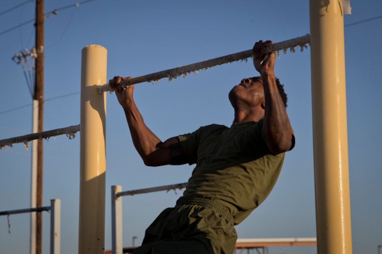U.S. Marines with Headquarters and Headquarters Squadron, Marine Corps Air Station Yuma, conduct the pull-up portion of the Physical Fitness Test (PFT) at Marine Corps Air Station Yuma Ariz., May 8, 2019. The PFT is an annual requirement for all Marines, and consists of pull-ups, crunches, and a 3 mile run. (U.S. Marine Corps photo by Lance Cpl. Joel Soriano)