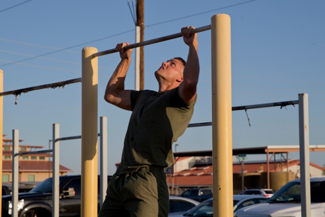 U.S. Marines with Headquarters and Headquarters Squadron, Marine Corps Air Station Yuma, conduct the pull-up portion of the Physical Fitness Test (PFT) at Marine Corps Air Station Yuma Ariz., May 8, 2019. The PFT is an annual requirement for all Marines, and consists of pull-ups, crunches, and a 3 mile run. (U.S. Marine Corps photo by Lance Cpl. Joel Soriano)