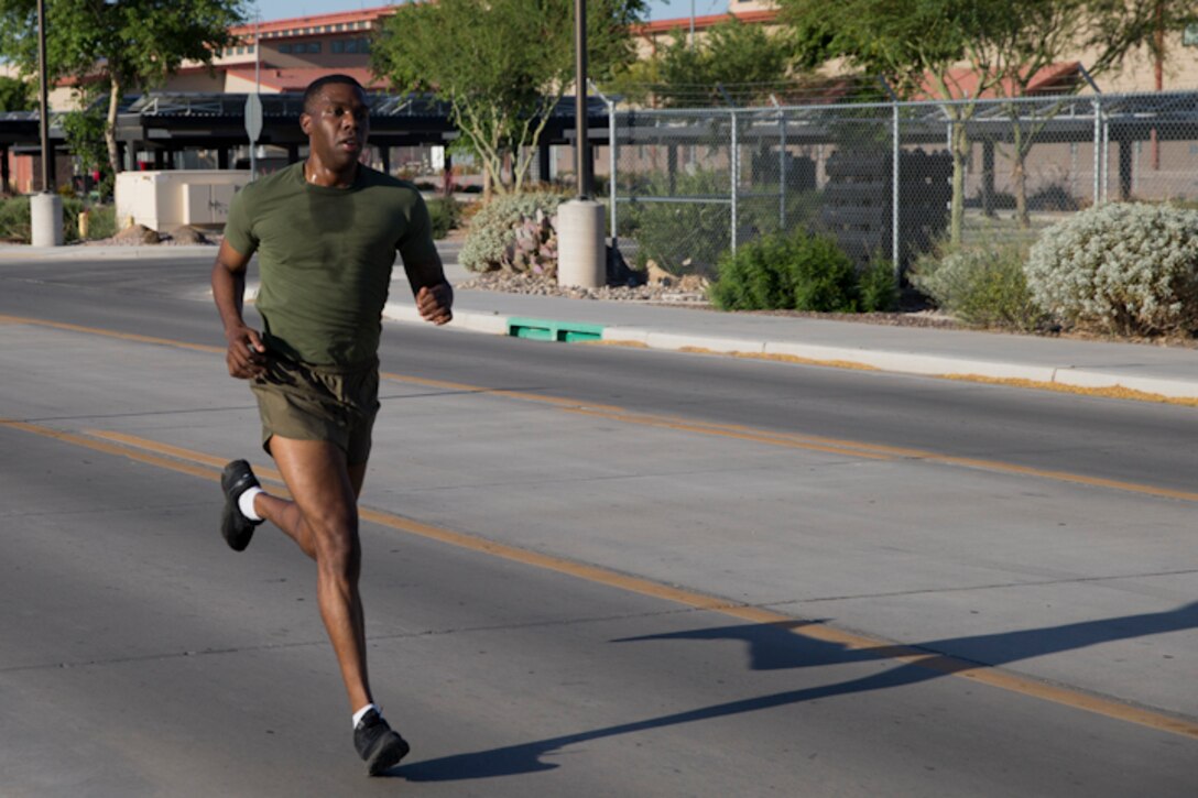 U.S. Marines with Headquarters and Headquarters Squadron, Marine Corps Air Station Yuma, conduct the pull-up portion of the Physical Fitness Test (PFT) at Marine Corps Air Station Yuma Ariz., May 8, 2019. The PFT is an annual requirement for all Marines, and consists of pull-ups, crunches, and a 3 mile run. (U.S. Marine Corps photo by Lance Cpl. Joel Soriano)