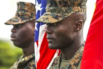 U.S. Marine Corps Sgt. Essozolim G. Amana holds the U.S. flag during a change of command ceremony June 4, 2019 on Camp Kinser, Okinawa, Japan. Lt. Col. Kevin M. Chunn, a native of Bernalillo, New Mexico, relinquished command of 3rd Supply Battalion, Combat Logistics Regiment 35, 3rd Marine Logistics Group, to Lt. Col. Robert D. Wolfe II, a native of Columbus, Mississippi, during the ceremony. Amana, the color sergeant for 3rd Supply Bn., CLR-35, 3rd MLG, is a native of Philadelphia, Pennsylvania. (U.S. Marine Corps photo by Cpl. Joshua S. Pinkney)