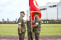 U.S. Marine Corps Lt. Col. Kevin M. Chunn passes the regimental colors to Lt. Col. Robert D. Wolfe II during a change of command ceremony June 4, 2019 on Camp Kinser, Okinawa, Japan. Chunn, a native of Bernalillo, New Mexico, relinquished command of 3rd Supply Battalion, Combat Logistics Regiment 35, 3rd Marine Logistics Group, to Wolfe II, a native of Columbus, Mississippi, during the ceremony. (U.S. Marine Corps photo by Cpl. Joshua S. Pinkney)