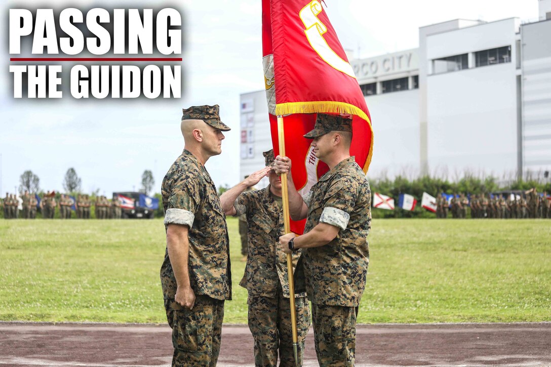 U.S. Marine Corps Lt. Col. Kevin M. Chunn passes the regimental colors to Lt. Col. Robert D. Wolfe II during a change of command ceremony June 4, 2019 on Camp Kinser, Okinawa, Japan. Chunn, a native of Bernalillo, New Mexico, relinquished command of 3rd Supply Battalion, Combat Logistics Regiment 35, 3rd Marine Logistics Group, to Wolfe II, a native of Columbus, Mississippi, during the ceremony. (U.S. Marine Corps photo by Cpl. Joshua S. Pinkney)