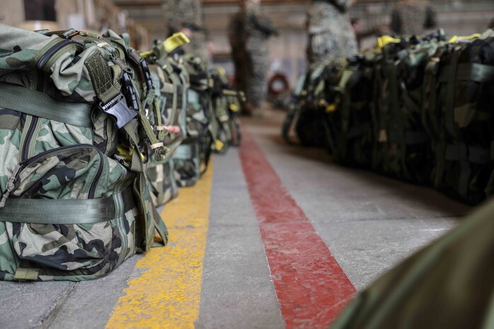 U.S. Marine Corps air delivery specialists prepare equipment for an air delivery exercise June 6, 2019 on Marine Corps Air Station Futenma, Okinawa, Japan. Air delivery specialists with Air Delivery Platoon, Landing Support Company, 3rd Transportation Support Battalion, Combat Logistics Regiment 3, 3rd Marine Logistics Group, employed the Joint Precision Airdrop System to enhance mission readiness by providing hands-on rehearsals. The JPADS is an autonomous system designed to provide accurate delivery of cargo and supplies to ground component forces. (U.S. Marine Corps photo by Lance Cpl. Mark Fike)