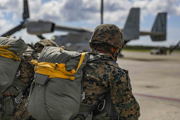 U.S. Marine Corps air delivery specialists prepare to board an MV-22 Osprey for an air delivery exercise June 6, 2019 on Marine Corps Air Station Futenma, Okinawa, Japan. Air delivery specialists with Air Delivery Platoon, Landing Support Company, 3rd Transportation Support Battalion, Combat Logistics Regiment 3, 3rd Marine Logistics Group, employed the Joint Precision Airdrop System to enhance mission readiness by providing hands-on rehearsals. The JPADS is an autonomous system designed to provide accurate delivery of cargo and supplies to ground component forces. (U.S. Marine Corps photo by Lance Cpl. Mark Fike)