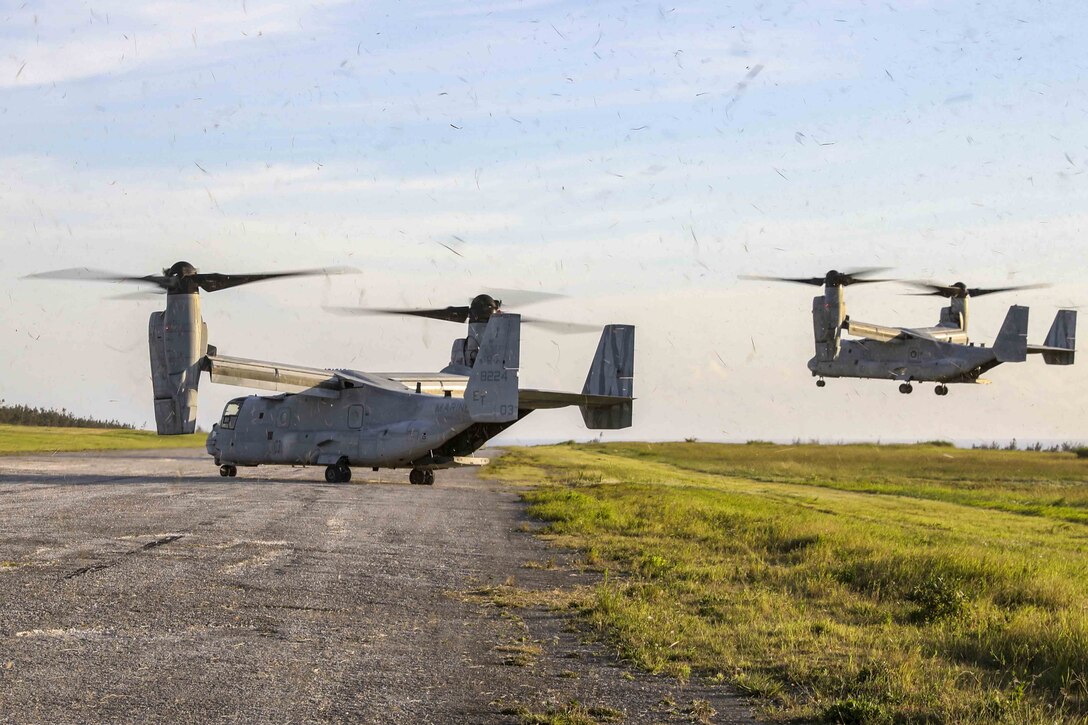 U.S. Marine Corps MV-22 Ospreys with Marine Medium Tiltrotor Squadron 262, 1st Marine Aircraft Wing, land at a drop zone on Ie Shima, Okinawa, Japan June 6, 2019.  Air delivery specialists with Air Delivery Platoon, Landing Support Company, 3rd Transportation Support Battalion, Combat Logistics Regiment 3, 3rd Marine Logistics Group, employed the Joint Precision Airdrop System to enhance mission readiness by providing hands-on rehearsals. The JPADS is an autonomous system designed to provide accurate delivery of cargo and supplies to ground component forces. (U.S. Marine Corps photo by Lance Cpl. Mark Fike)