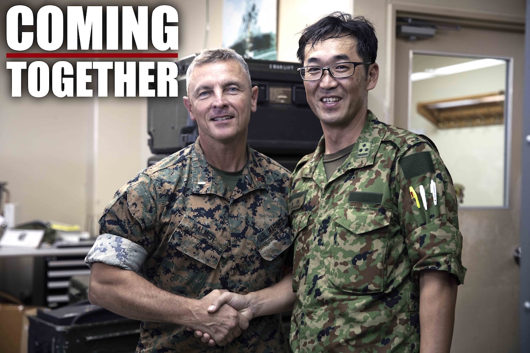 U.S. Marine Corps Chief Warrant Officer 4 Roderick Palmer shakes hands with Japanese Ground Self-Defense Force Capt. Yuki Sonoda during a community exchange program tour on Camp Kinser, Okinawa, Japan June 7, 2019. During the tour, hosted by Combat Logistics Regiment 35, service members visited the base dining facility, supply management unit, a maintenance shop and the Battle of Okinawa historical display, before taking part in a social at the USO. The purpose of the program is to create bonds and increase operational understanding between the JGSDF and the U.S. Marine Corps. Palmer, the company commander of Maintenance Company, CLR-35, 3rd Marine Logistics Group, is a native of Tallahassee, Florida. Sonoda is a native of Fukuoka, Japan.  (U.S. Marine Corps photo by Pfc. Courtney A. Robertson)