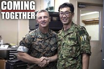 U.S. Marine Corps Chief Warrant Officer 4 Roderick Palmer shakes hands with Japanese Ground Self-Defense Force Capt. Yuki Sonoda during a community exchange program tour on Camp Kinser, Okinawa, Japan June 7, 2019. During the tour, hosted by Combat Logistics Regiment 35, service members visited the base dining facility, supply management unit, a maintenance shop and the Battle of Okinawa historical display, before taking part in a social at the USO. The purpose of the program is to create bonds and increase operational understanding between the JGSDF and the U.S. Marine Corps. Palmer, the company commander of Maintenance Company, CLR-35, 3rd Marine Logistics Group, is a native of Tallahassee, Florida. Sonoda is a native of Fukuoka, Japan.  (U.S. Marine Corps photo by Pfc. Courtney A. Robertson)