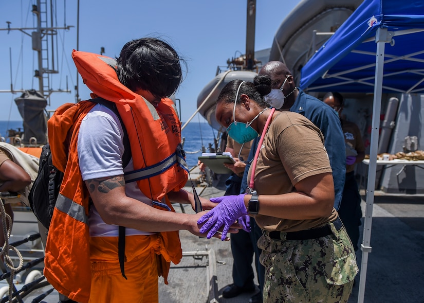 GULF OF OMAN (June 13, 2019) Sailors aboard the Arleigh Burke-class guided-missile destroyer USS Bainbridge (DDG 96) render aid to the crew of the M/V Kokuka Courageous. Bainbridge is deployed to the U.S. 5th Fleet areas of operations in support of naval operations to ensure maritime stability and security in the Central Region, connecting the Mediterranean and Pacific through the Western Indian Ocean and three strategic choke points. (U.S. Navy photo by Mass Communication Specialist 3rd Class Jason Waite/Released)