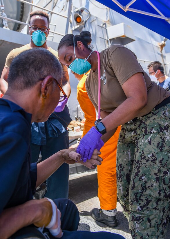 GULF OF OMAN (June 13, 2019) Sailors aboard the Arleigh Burke-class guided-missile destroyer USS Bainbridge (DDG 96) render aid to the crew of the M/V Kokuka Courageous. Bainbridge is deployed to the U.S. 5th Fleet areas of operations in support of naval operations to ensure maritime stability and security in the Central Region, connecting the Mediterranean and Pacific through the Western Indian Ocean and three strategic choke points. (U.S. Navy photo by Mass Communication Specialist 3rd Class Jason Waite/Released)