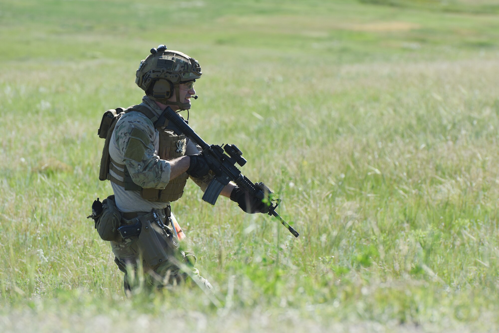 An Airman with the 341st Security Support Squadron tactical response force moves through a field during an integrated recapture and recovery exercise June 11, 2019, at an intercontinental ballistic missile launch facility near Simms, Mont.