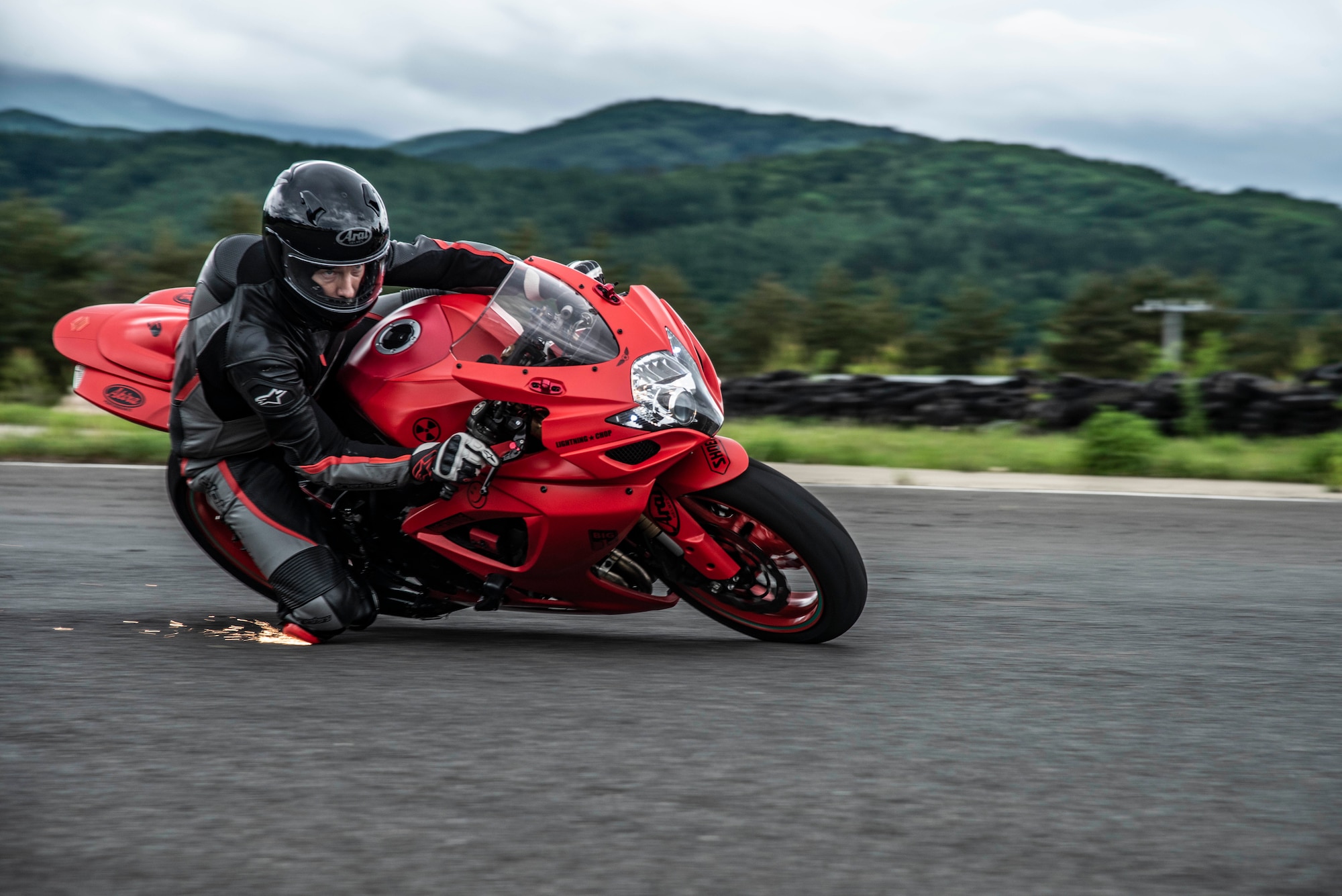 U.S. Air Force Master Sgt. Michael Yurco, the 35th Security Forces Squadron echo-flight chief, causes sparks to fly while closely turning a corner at Aomori Speed Park in Aomori City, Japan, May 28, 2019. Yurco attached magnesium knee sliders specifically made for super sports to create the effect. (U.S. Air Force photo by Senior Airman Sadie Colbert)