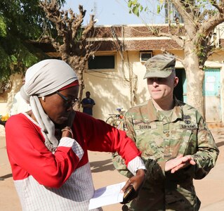 Dr. Theresa Aida B. Ndiaye, director of the Regional Center Hospital at Tambacounda, Senegal, and U.S. Army Maj. Christopher Gookin review the list of supplies that were brought to Senegal, on April 9, 2019. Vermont Guardsmen worked with their Senegalese  counterparts to share best practices while providing the Department of Defense with cost-effective ways to strengthen alliances and attract new partners in conjunction with the State Partnership Program.
