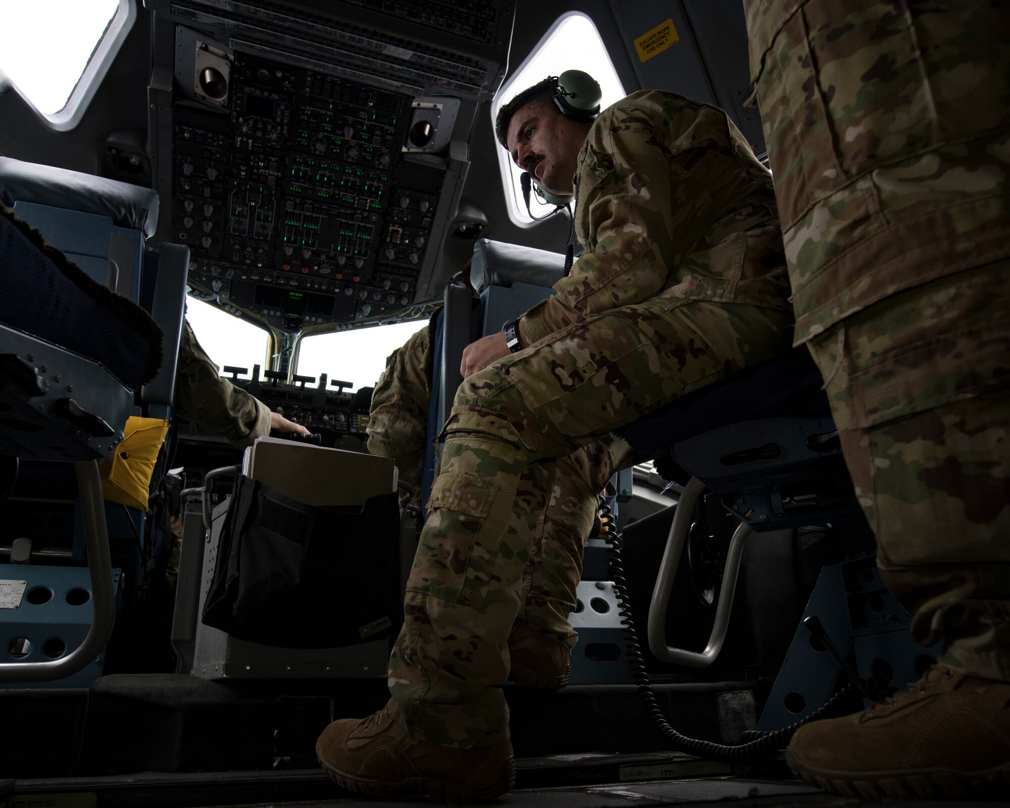 Maj. Jonathan Mahan, a C-17 Globemaster III pilot assigned to the 14th Airlift Squadron, listens to interaircraft communications May 14, 2019, during flight training operations over the Gulf of Mexico.