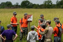 U.S. Army Sgt. John Kumke, Recruiting and Retention Battalion recruiter, teaches Air Force Junior ROTC cadets, participating in the Cadet Leadership Course, how to find distance and direction between two points and successfully navigate a medium terrain course with only a map and compass, June 4, 2019 at the Illinois Army National Guard Training Complex in Sparta, Ill. (U.S. Air Force photo by Senior Airman Daniel Garcia)