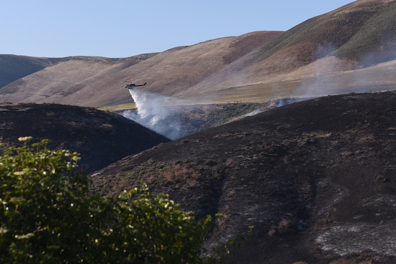 A helicopter assists in containing the Rancho Fire, which burned approximately 140 acres near Point Sal and El Rancho roads June 13, 2019 at Vandenberg Air Force Base, Calif. No base structures were threatened during this fire.