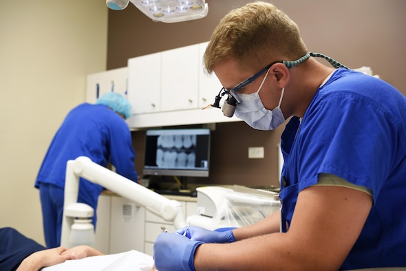 Capt. Travis Wagner, 14th Medical Operations Squadron dentist, works with a patient June 11, 2019, on Columbus Air Force Base, Mississippi. The dental clinic is the only 14th MDOS flight located on the second floor. They provide trusted care to retirees, all active-duty members and their family. (U.S. Air Force photo by Senior Airman Keith Holcomb)