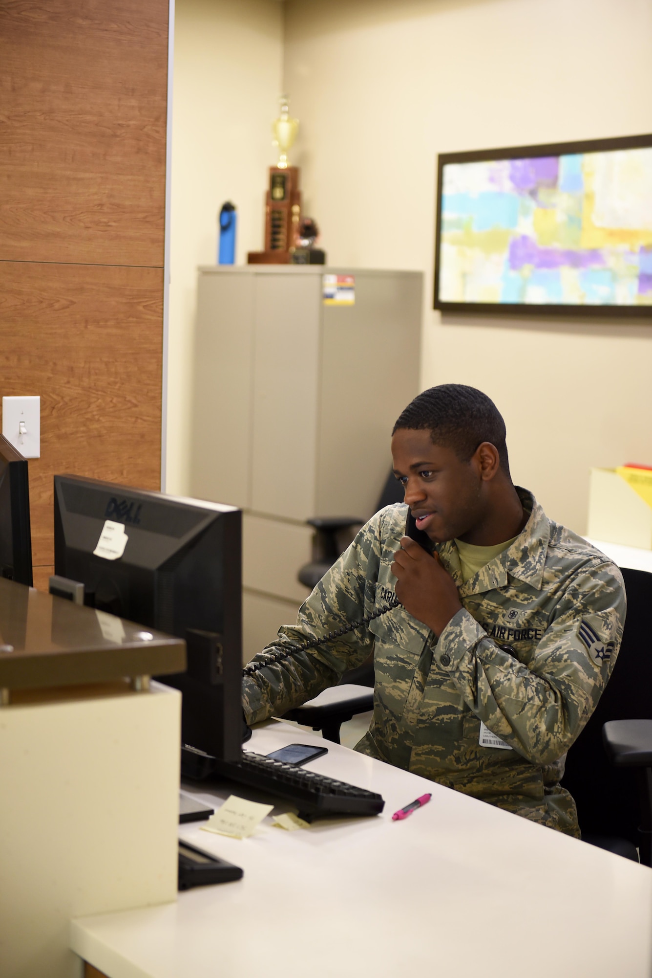 Senior Airman Jacob Caruthers, 14th Medical Operations Squadron family health office manager, speaks on the phone June 11, 2019, on Columbus Air Force Base, Mississippi. Caruthers and his co-workers work hard to help anyone with any medical group issue and will give directions on where to go or help schedule an appointment. (U.S. Air Force photo by Senior Airman Keith Holcomb)