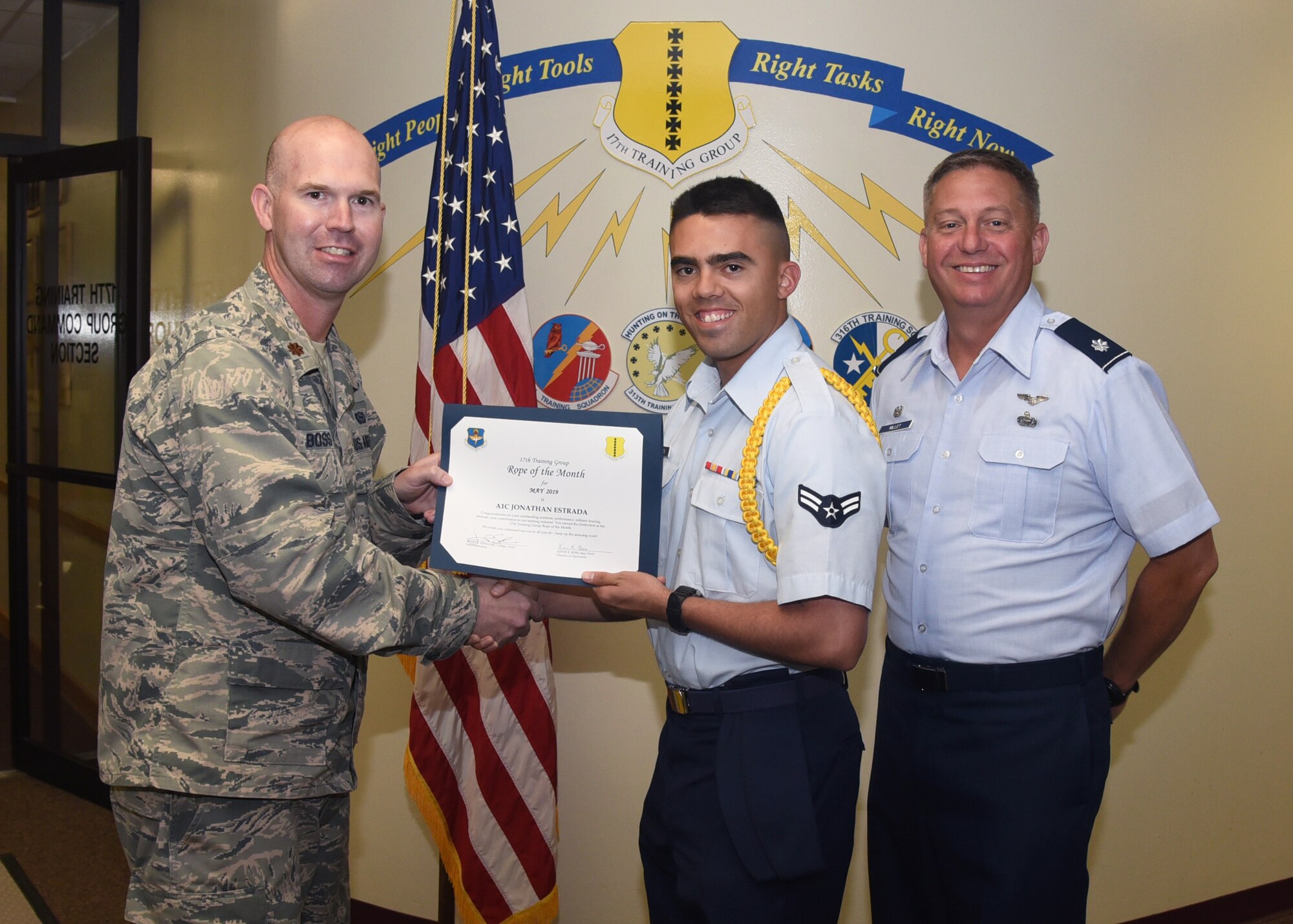 U.S. Air Force Maj. Kevin Boss, 17th Training Group director of operations, presents the Rope of the Month award to Airman 1st Class Jonathon Estrada, 315th Training Squadron student at the Brandenburg Hall on Goodfellow Air Force Base, Texas, June 7, 2019. Military Training Leaders present ropes to Airmen who display exceptional leadership qualities to lead their peers. (U.S. Air Force photo by Airman 1st Class Abbey Rieves/Released)