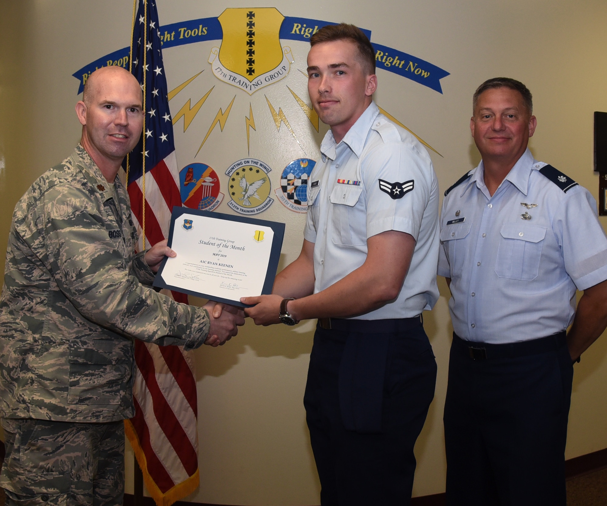 U.S. Air Force Maj. Kevin Boss, 17th Training Group director of operations, presents the 315th Training Squadron Student of the Month award to Airman 1st Class Ryan Keenen, 315th TRS student, at the Brandenburg Hall on Goodfellow Air Force Base, Texas, June 7, 2019. The 315th TRS’s vision is to develop combat-ready intelligence, surveillance and reconnaissance professionals and promote an innovative squadron culture and identity unmatched across the U.S. Air Force. (U.S. Air Force photo by Airman 1st Class Abbey Rieves/Released)