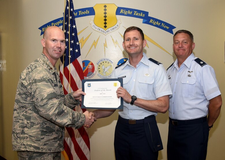 U.S. Air Force Maj. Kevin Boss, 17th Training Group director of operations, presents the 315th Training Squadron Student of the Month award to Air1st Lt. Sage Cummingham, 315th TRS student, at the Brandenburg Hall on Goodfellow Air Force Base, Texas, June 7, 2019. The 315th TRS’s vision is to develop combat-ready intelligence, surveillance and reconnaissance professionals and promote an innovative squadron culture and identity unmatched across the U.S. Air Force. (U.S. Air Force photo by Airman 1st Class Abbey Rieves/Released)