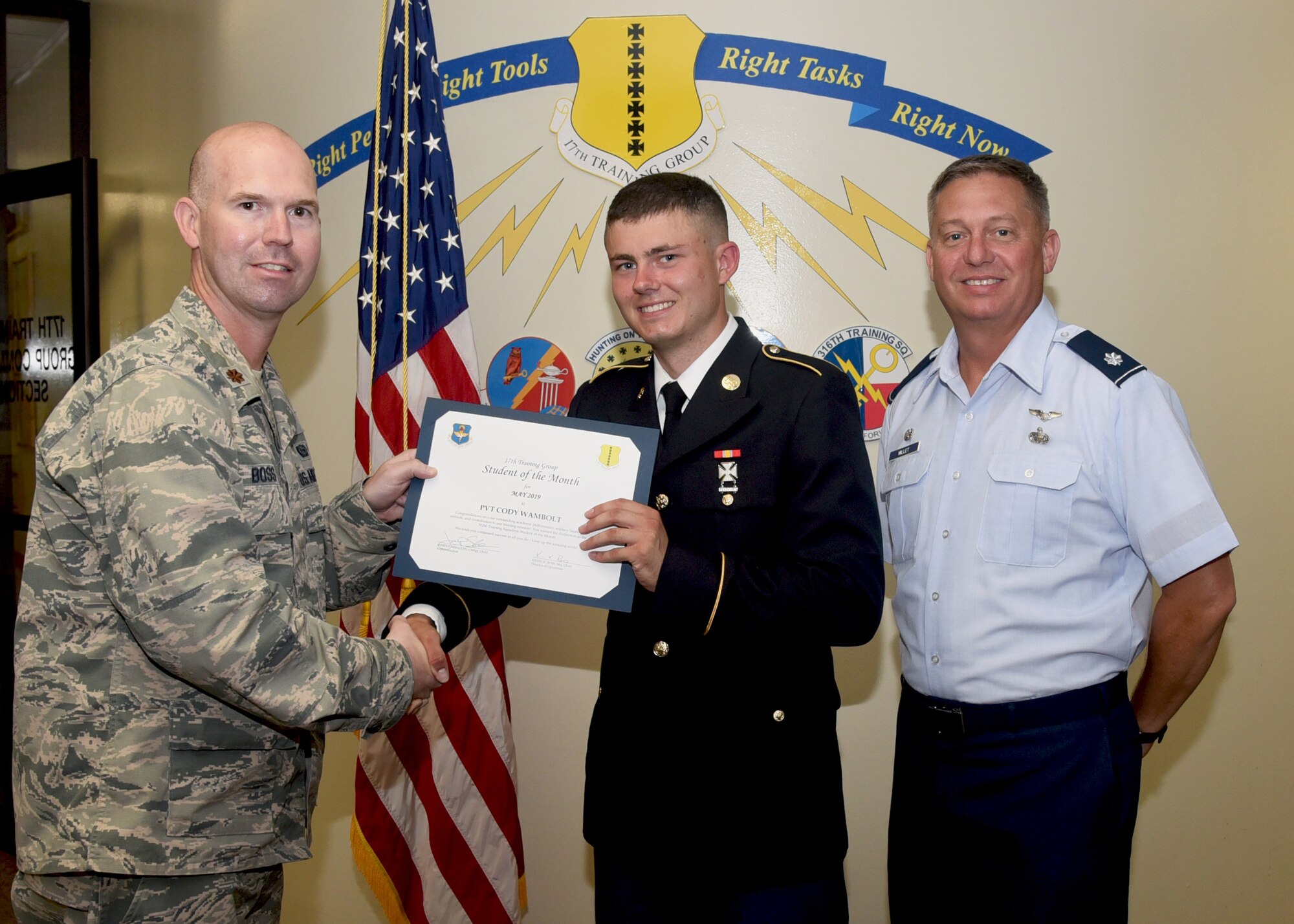 U.S. Air Force Maj. Kevin Boss, 17th Training Group director of operations, presents the 312th Training Squadron Student of the Month award to U.S. Army PVT Cody Wambolt, 312th TRS student, at the Brandenburg Hall on Goodfellow Air Force Base, Texas, June 7, 2019. The 312th TRS’s mission is to provide Department of Defense and international customers with mission ready fire protection and special instruments graduates and provide mission support for the Air Force Technical Applications Center. (U.S. Air Force photo by Airman 1st Class Abbey Rieves/Released)