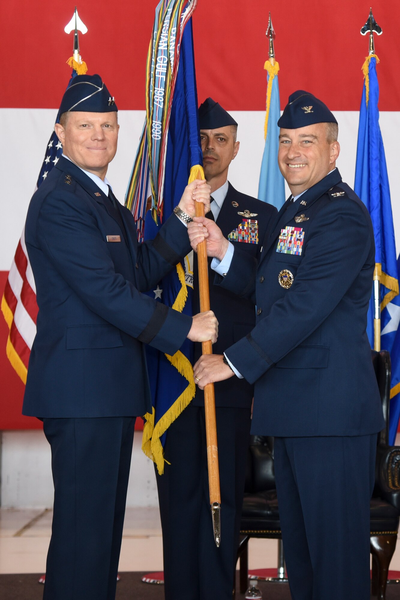 Col. Alain D. Poisson, right, accepts the guideon for the 552nd Air Control Wing from Maj. Gen. Andrew A. Croft, 12th Air Force (Air Forces Southern) commander, during the change of command ceremony June 10, 2019, Tinker Air Force Base, Oklahoma. Col. Geoffrey Weiss relinquished command of the 552 ACW to Col. Alain D. Poisson. (U.S. Air Force photo/Greg L. Davis)