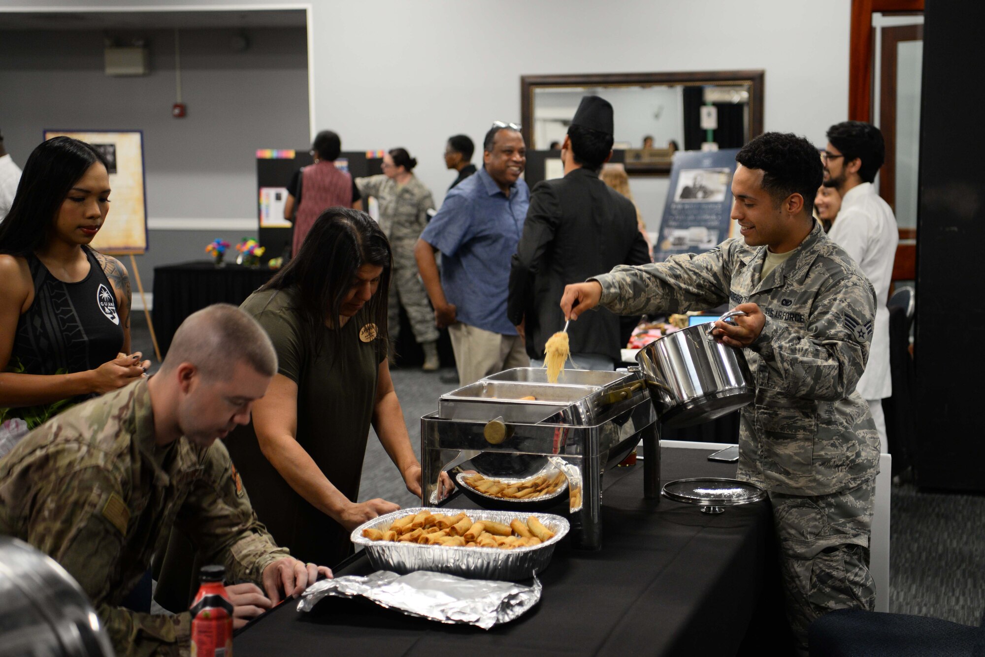 Booth attendants getting food and area ready before Diversity Day starts, June 7, 2019, on Columbus Air Force Base, Miss. Diversity Day featured different cultures and gave participants the chance to educate others on the history of their backgrounds. (U.S. Air Force photo by Airman 1st Class Jake Jacobsen)